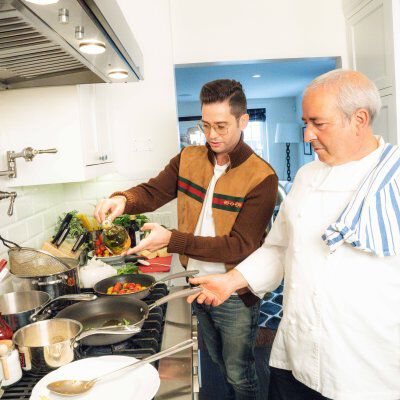 Josh Flagg cooking in kitchen with another person